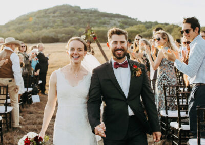 couple walking back up aisle on hawkins hope ranch in blanco texas wedding venue