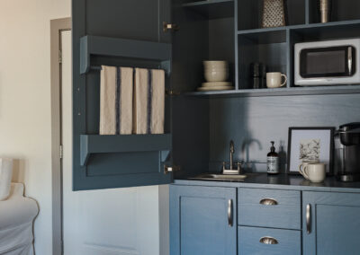 dark blue cabinets with a microwave inside