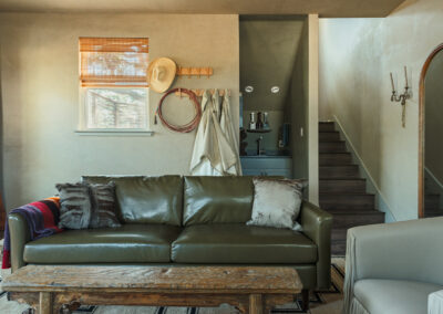 rustic leather couch sitting inside the treehouse at hawkins hope ranch