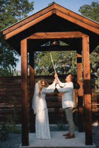 couple ringing a wedding bell at hawkins hope ranch wedding venue