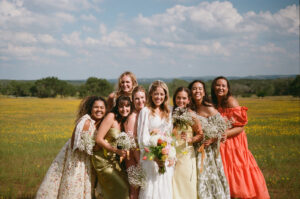 bride and her friends in a flower field at hawkins hope ranch texas